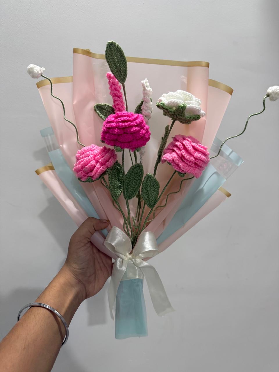 Crochet rose bouquet in pink and white wrapped in blush and mint paper with a cream bow
